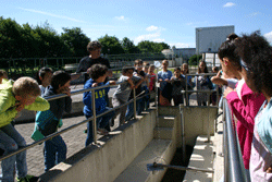 Eine Gruppe von Schulkindern steht an einer der Anlagen des Klärwerkes.